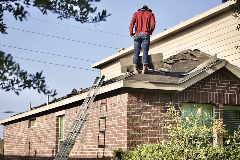 Professional roofer working on a residential roof in Oakton
